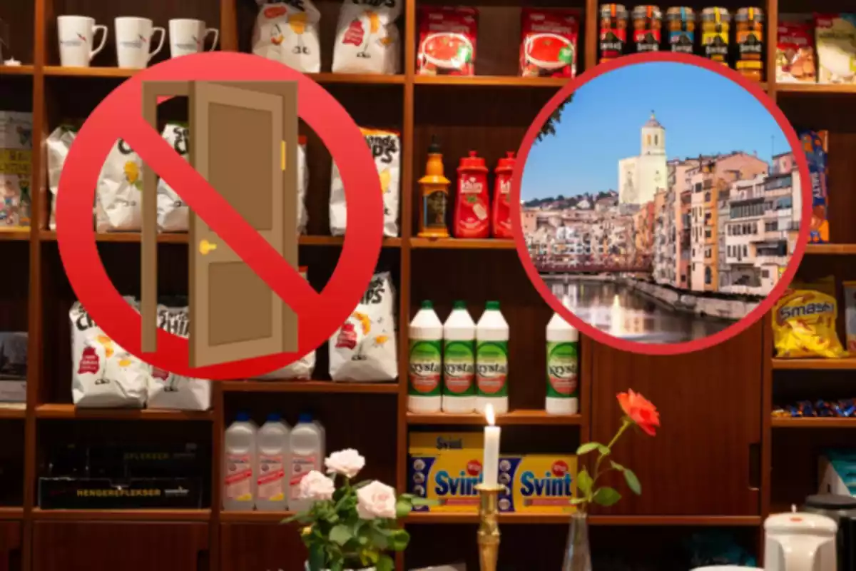 Botiga queviures amb un emoji d'una porta amb un prohibit i una imatge de Girona