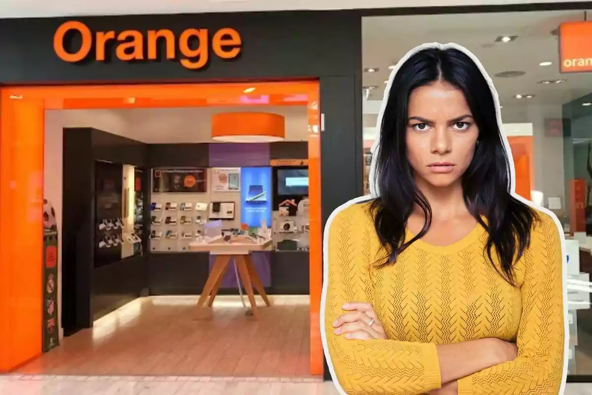 Una dona amb expressió seriosa està davant d'una botiga de la companyia Orange.