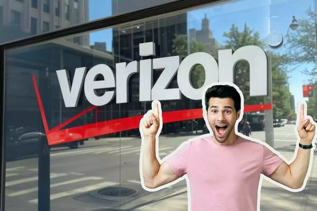 Excited man in front of a Verizon store in the city.